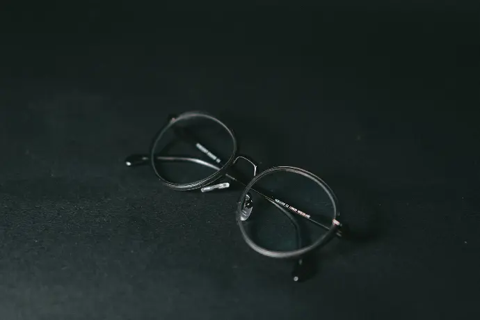 silver framed eyeglasses on black textile